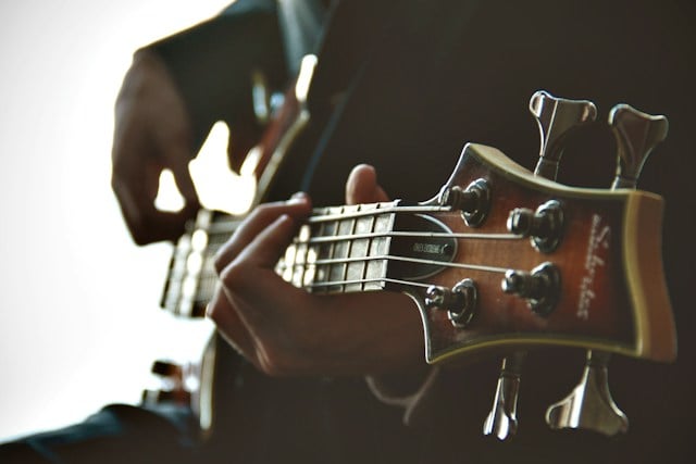 Close-up of a musician playing guitar during a heartfelt memorial service in Healdsburg, CA.